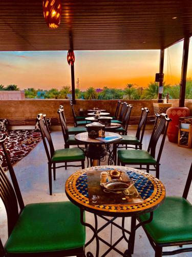a patio with tables and chairs with a view at Jawharat Alaqar Inn نزل جوهرة العقر in Nizwa
