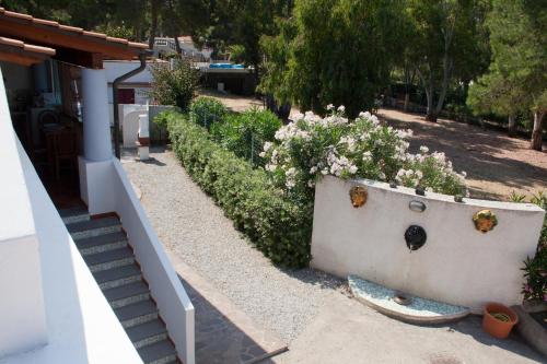 a garden with a white fence and some flowers at Villa Crimi in Vulcano