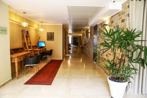 a corridor of an office with a plant at Garden Hotel Boutique & Events in Haifa