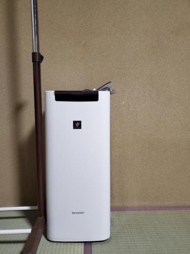 a small white refrigerator sitting in a room at Naoshima Kowloon in Naoshima