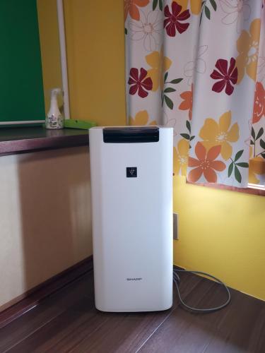 a white refrigerator sitting on the floor in a room at Naoshima Kowloon in Naoshima