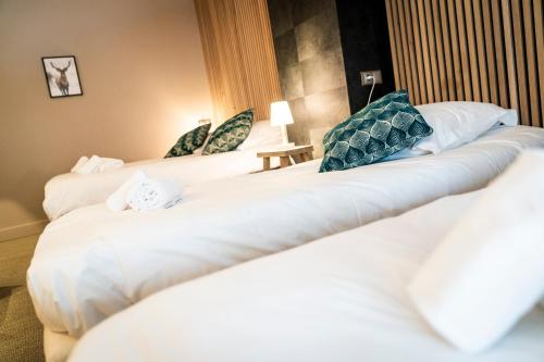 a row of beds in a hotel room at Domaine du Mont-Saint-Jean in Les Rousses