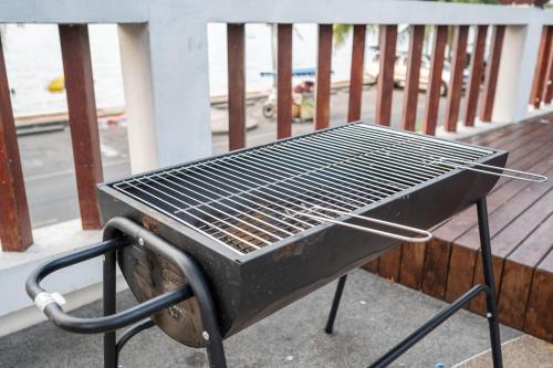 a grill sitting on top of a balcony at RimLay Beachfront Pool Villa in Sattahip