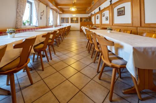 a row of tables and chairs in a room at Gasthof Geier in Wörth an der Donau