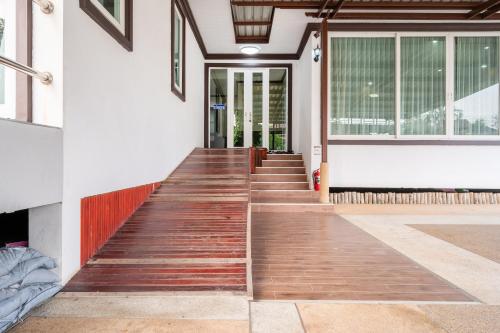 a hallway of a house with wooden stairs at RimLay Beachfront Pool Villa in Sattahip