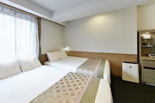 Postel nebo postele na pokoji v ubytování The Bridge Hotel Shinsaibashi