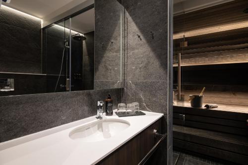 a bathroom with a sink and a shower at Lapland Hotels Arena in Tampere