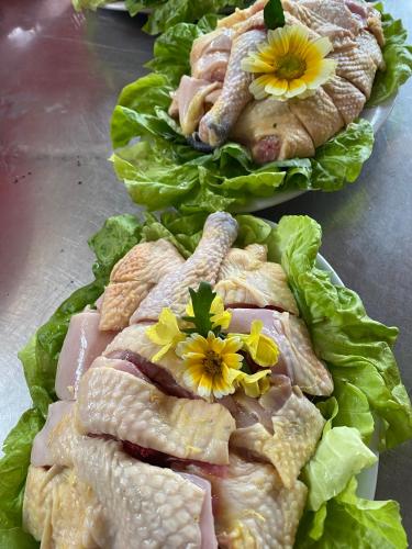 a bunch of food with flowers on top of lettuce at Nasan Green Farm in Cao Bằng