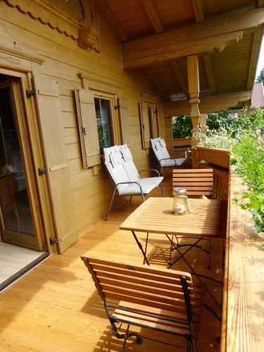 a patio with a table and chairs on a porch at Appartement Bergrose in Hopfgarten im Brixental