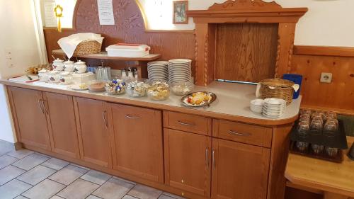 a kitchen with a counter with dishes on it at Gasthof Schöntal in Oberau