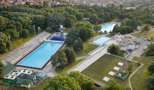 an overhead view of a swimming pool in a park at Cozy green house (free parking spot) in Belgrade