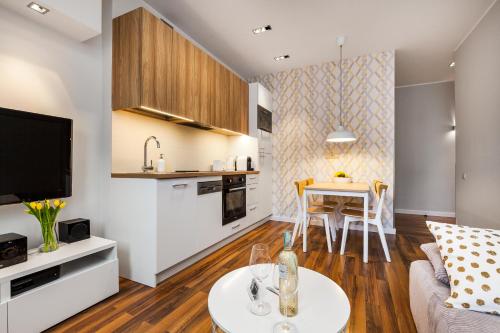 a living room with a couch and a table at Apartamenty Black&White in Gdynia