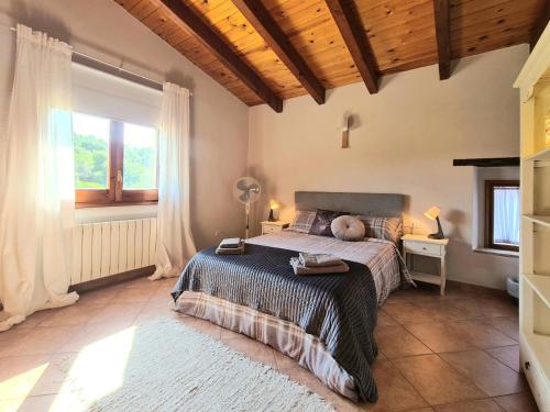 a bedroom with a bed and a large window at Harveys Homestay - Adults only in Mieres