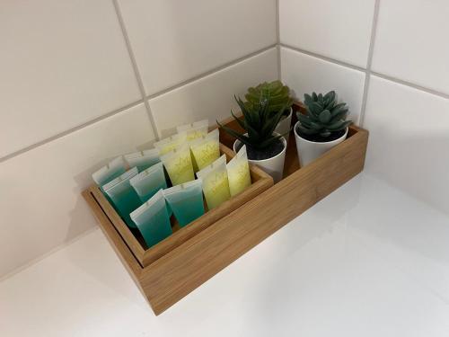 a wooden shelf with potted plants on a wall at Tampere City view near Nokia Arena AC in Tampere