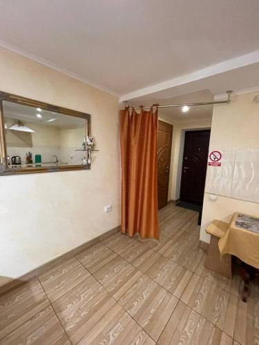 an empty room with a mirror and a wooden floor at Апартаменты SunRise in Kamianets-Podilskyi