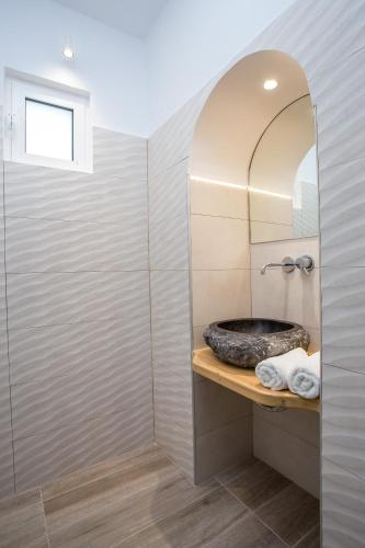 a bathroom with a sink and a mirror at Muses Hotel in Faliraki