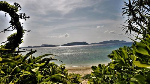 a beach with a view of the ocean at ペンションニライカナイ NiraiKanai in Awaren