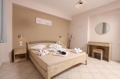 a bedroom with a bed with towels on it at Summer Dream Hotel in Polykhrono