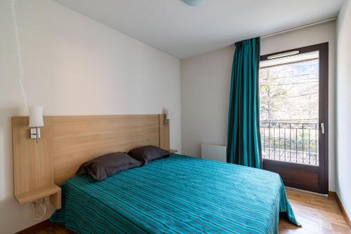 En eller flere senge i et værelse på Les Jardins de Ramel - Apt proche des pistes avec Wifi
