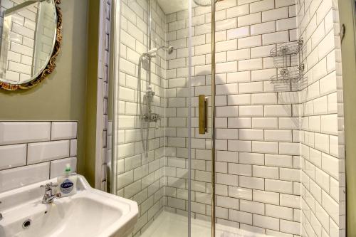 a bathroom with a shower and a sink at Central Huddersfield House, inc parking in Huddersfield