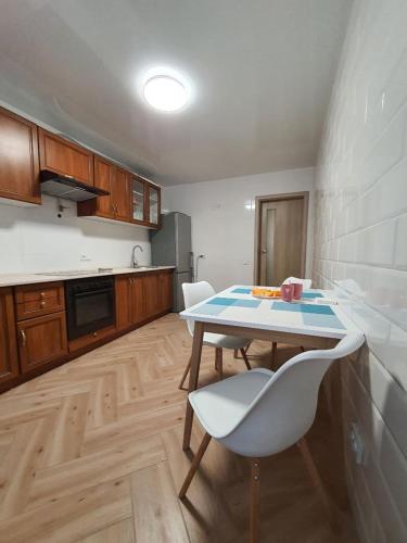a kitchen with a table and chairs in a room at Апартаменти Класик у ЖК Яровиця in Luts'k