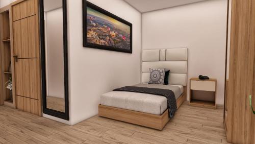 a bedroom with a bed and a painting on the wall at Kutlucan Oldtown in Bursa