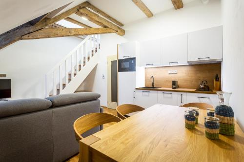 a kitchen and dining room with a table and a couch at U Pivovaru - Apartments Boží Dar in Boží Dar