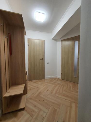 an empty room with wooden floors and a door at Апартаменти Класик у ЖК Яровиця in Luts'k