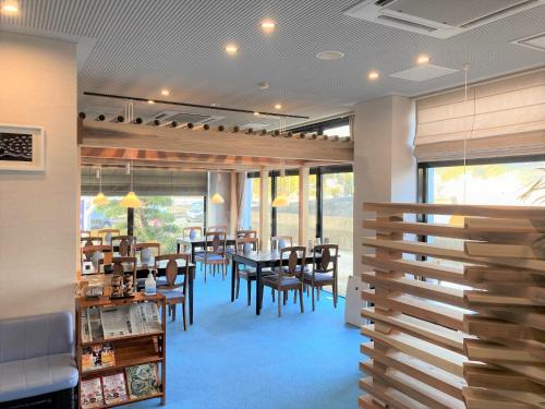 a restaurant with a dining room with tables and chairs at Bayside Hotel Ryugu / Vacation STAY 63706 in Anan