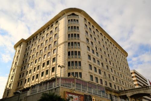 a large white building with a balcony at SABIHA GOKCEN HOTEL İSTANBUL HOUSES in Istanbul