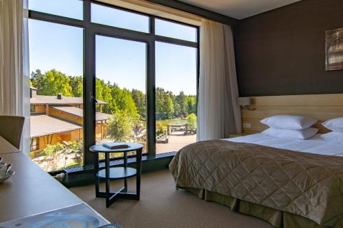 a hotel room with a bed and a large window at ArtiLand in Balashikha