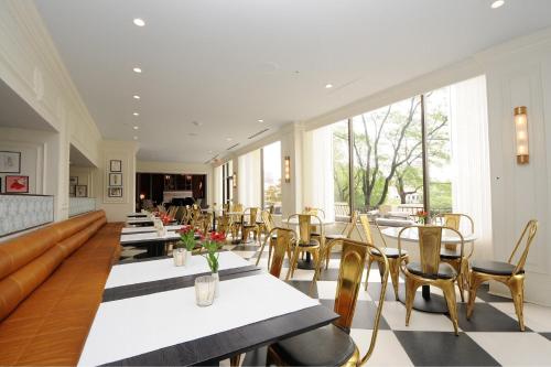 a restaurant with tables and chairs and windows at InterContinental Kansas City at the Plaza by IHG in Kansas City
