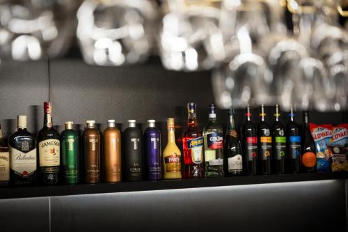 a shelf full of different types of bottles of alcohol at Hotel Granit Nová Polianka*** - klimatické kúpele in Vysoké Tatry