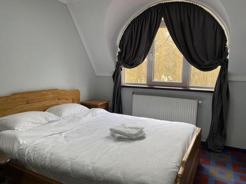 a bedroom with a bed with a robe on it at Leoton Chernivtsi in Chernivtsi