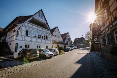 a street with cars parked on the side of a building at Hotel Restaurant Lamm Rosswag in Vaihingen an der Enz