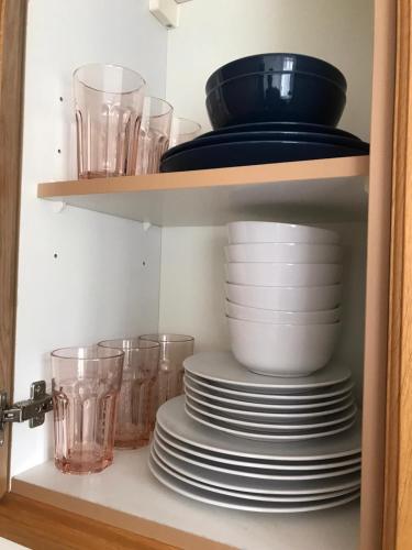 a cabinet filled with plates and bowls and glasses at Luxurious & Spacious 5 Bedroom Property in Belvedere