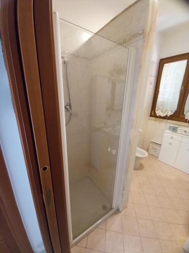 a shower with a glass door in a bathroom at Gio's house in Collemeto