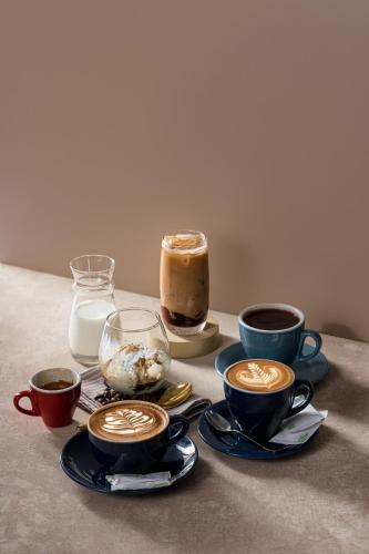 a group of cups of coffee on a table at Kala Hotel Semarang in Jomblang