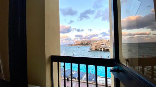 a view of the ocean from a hotel room window at St. Julian's Bay Hotel in St Julian's
