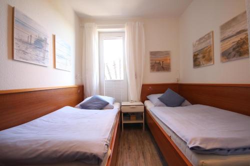 Кровать или кровати в номере Ferienwohnung 449 im Haus Knechtsand