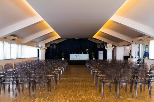 a room with chairs and a stage in the middle at Le Dune Sicily Hotel in Catania