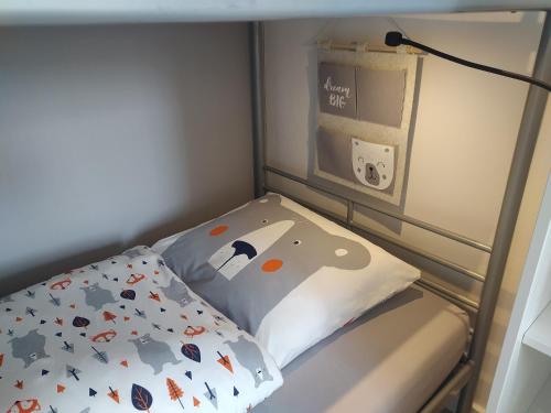 a small bed in a small room with a pillow at Family Inn Kaatsheuvel in Kaatsheuvel