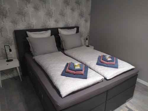 two twin beds with towels on top of them at Family Inn Kaatsheuvel in Kaatsheuvel
