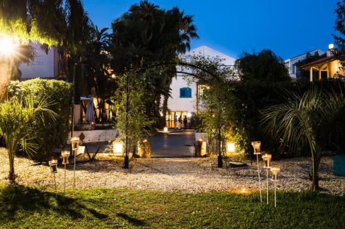 a garden at night with lights in the grass at Le Dune Sicily Hotel in Catania