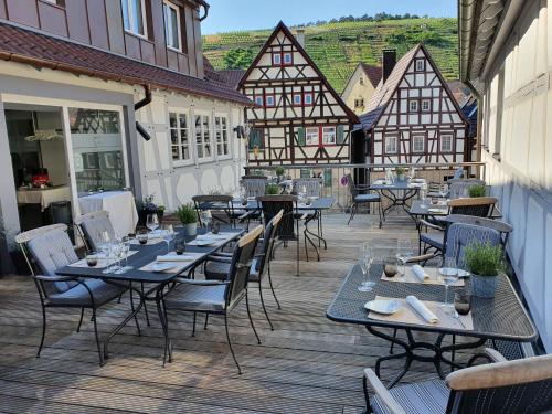 an outdoor patio with tables and chairs and buildings at Hotel Restaurant Lamm Rosswag in Vaihingen an der Enz
