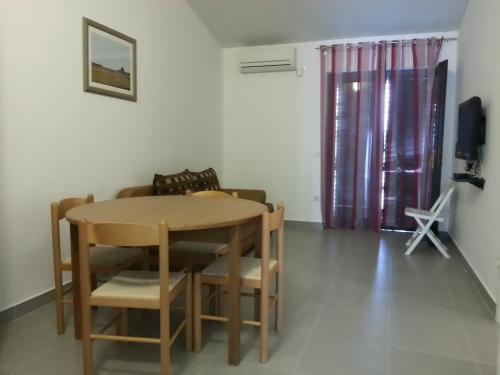 a table and chairs in a living room with a couch at 230 MESTRO in Stanići