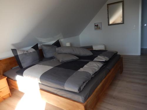 a bedroom with a large bed in a room at Ferienwohnung Karen&Lemmi in Risum-Lindholm