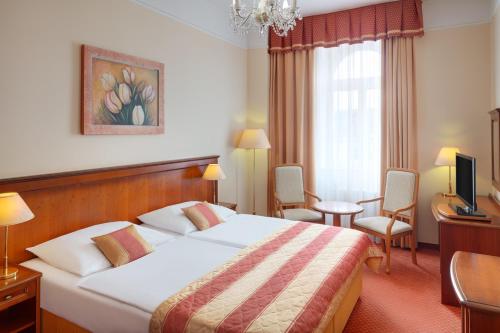 Postel nebo postele na pokoji v ubytování Ensana Centrální Lázně - Maria Spa