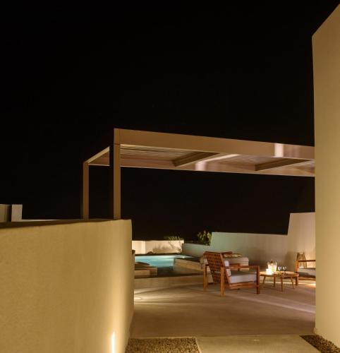 a living room with a bed and a couch at Potnia Theron Suites in Akrotiri