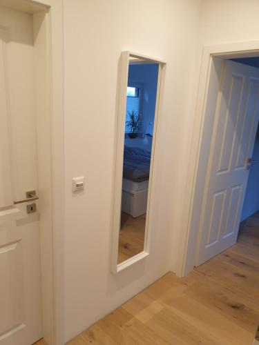 a hallway with a mirror and a bedroom at Willkommen zu Hause, ankommen & wohlfühlen ! in Tremsbüttel